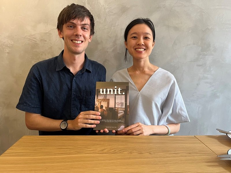Photo of Finbarr Fallon and Samantha Chia holding the "UNIT" book