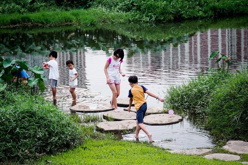 Kids playing at the river at Bishan Ang Mo Kio Park